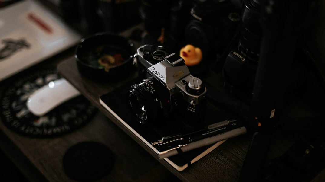 Compact home video editing desk with camera gear and a tablet for colour grading