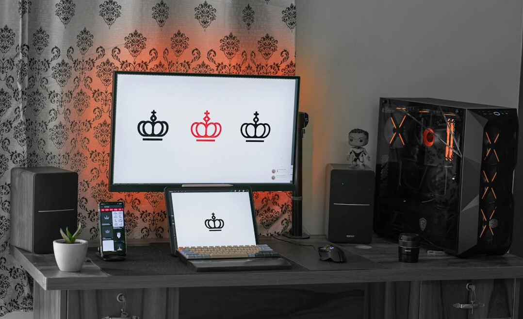 Video editing workstation with multiple monitors showing a timeline and colour scopes